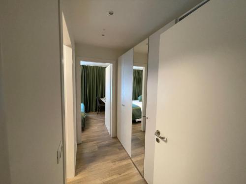 a hallway leading to a bedroom with a mirror at SAINT MICHEL in Gorizia