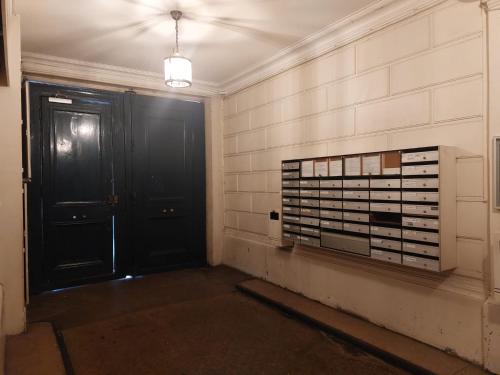 an empty room with a black door and some boxes at PARIS BASTILLE BERCY GARE DE LYON CHAMBRE CLIMATISEE 9m2 idéal 1 pers ,max 2 pers in Paris