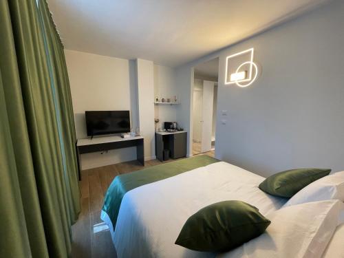 a hotel room with a bed and a television at SAINT MICHEL in Gorizia