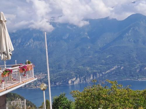 a view of a lake from a balcony with an umbrella at PROVINCIALE 79 in Magreglio
