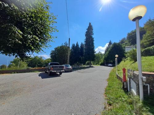 a truck driving down a road with cars on it at PROVINCIALE 79 in Magreglio
