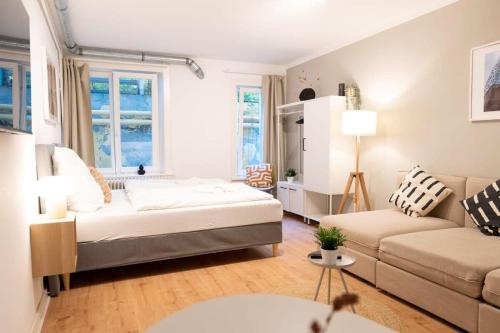a living room with a bed and a couch at Hamburg City Apartment for 5 in Hamburg