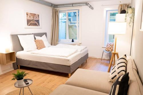 a living room with a bed and a couch at Hamburg City Apartment for 5 in Hamburg