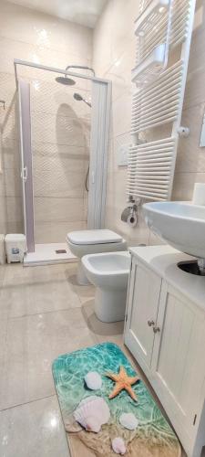 a bathroom with a sink and a toilet and a shower at Dimora della Marchesa - al Duomo in Manfredonia