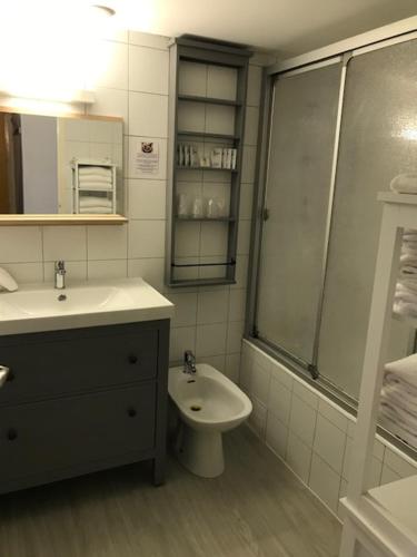 a bathroom with a sink and a toilet and a shower at Hotel Bord A Bord in Noirmoutier-en-l'lle