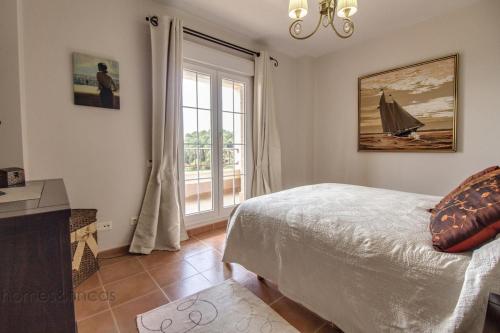a bedroom with a bed and a window at 3 Bed Beach Apartment with views Isla Canela in Isla Canela