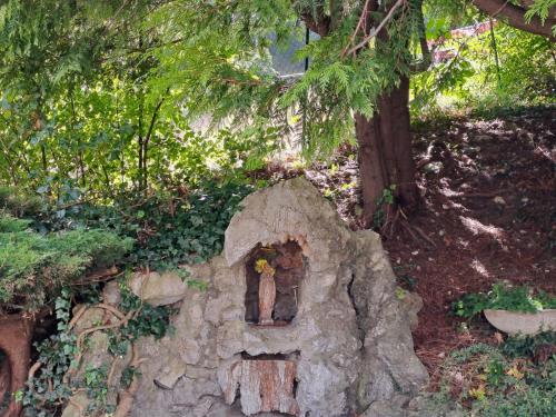 a stone house with a window in a tree at PROVINCIALE 79 in Magreglio