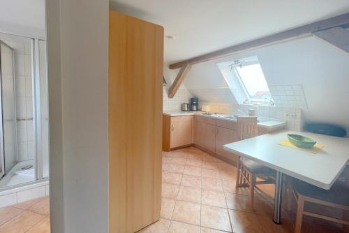 a kitchen with a table and a dining room at Haus Antje Studio in Kölpinsee