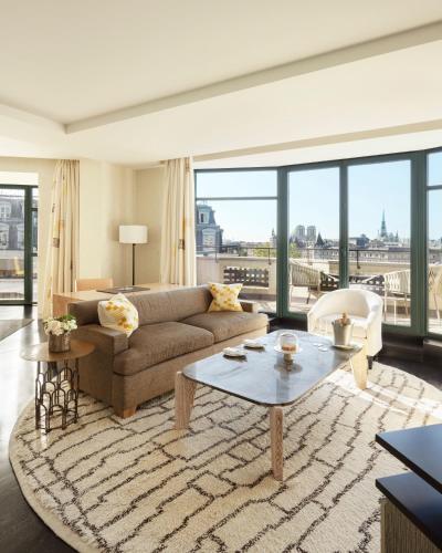 a living room with a couch and a table at Cheval Blanc Paris & Dior Spa Cheval Blanc Paris in Paris
