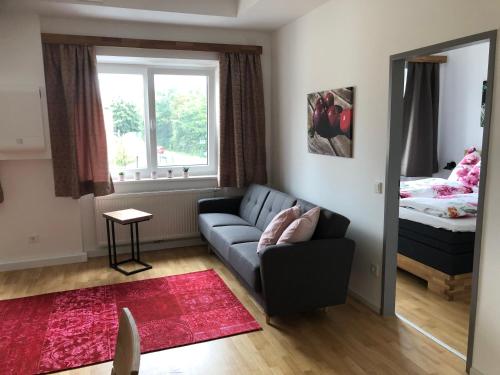 a living room with a couch and a bed at Garten Apartment in Nodendorf