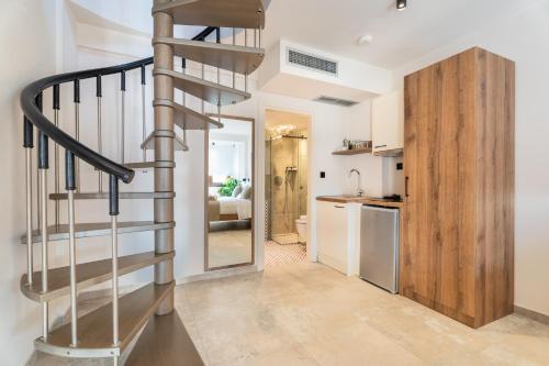 a spiral staircase in a room with a kitchen at Mpikas Holidays in Ierissos