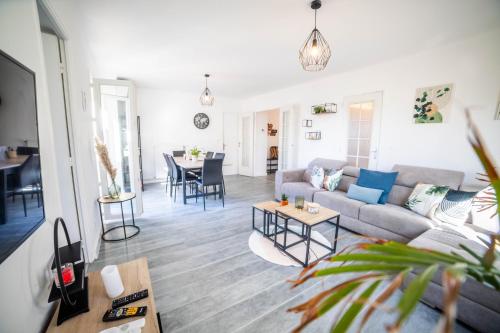 salon z kanapą i stołem w obiekcie VILLA COSYFAMILY PISCINE WIFI 15MIN PLAGE idéal FAMILLE - TopProsConciergerie w mieście Pérols