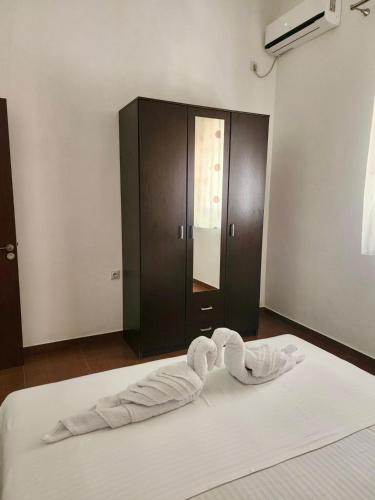a bed with a towel on top of it in a room at Sunrise Apart-Hotel in Ulcinj