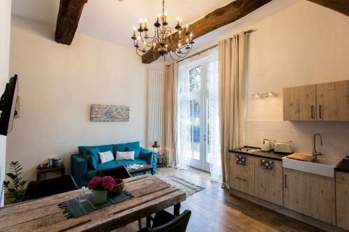 a kitchen and living room with a table and a couch at Gästehaus Gut Füchtel und Gut Welpe in Vechta