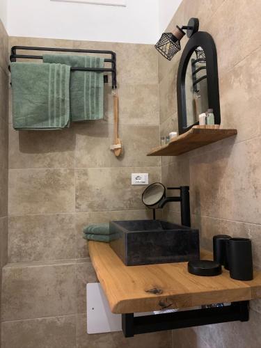 a bathroom with a black sink and a mirror at La Dolce Vista in Dolceacqua