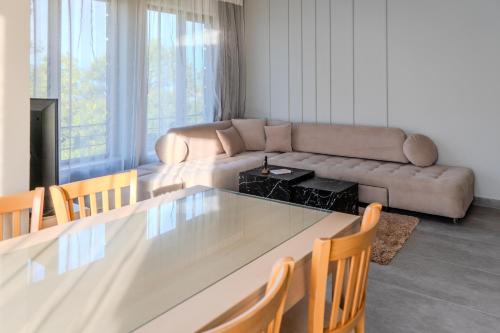 a living room with a table and a couch at Dion Apartments in Lozenets