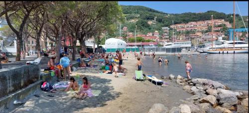 a group of people on a beach near the water at CASA AMELIA in Le Grazie