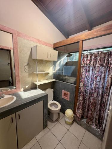 a small bathroom with a toilet and a sink at Casa de campo El Valle Inn in Lima