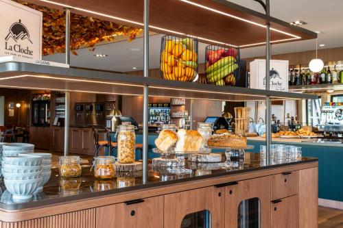 a bakery counter with bread and other food items at Mercure Bayeux Omaha Beach in Port-en-Bessin-Huppain