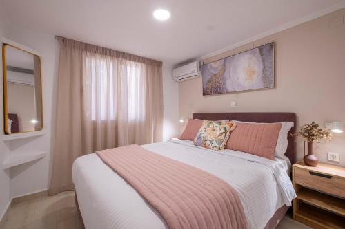 a bedroom with a large bed and a window at Tolo Villa Natura with Pool for 8 - private, luxury accommodation in Tolo