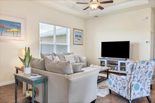 a living room with a couch and a flat screen tv at 10333 Monticello Dr in Port Charlotte