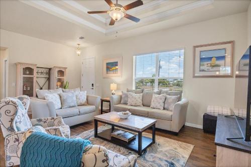 a living room with couches and a ceiling fan at 10333 Monticello Dr in Port Charlotte