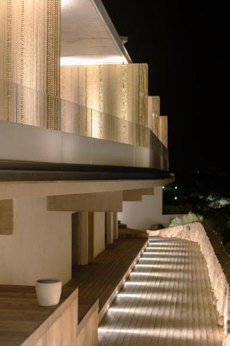 a night view of a building with a balcony at Villa Urbana in Porticcio