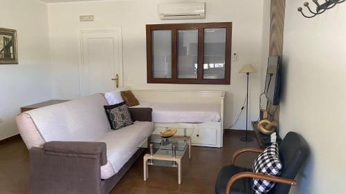 a living room with a couch and a television at ERAS 3 in Herencia