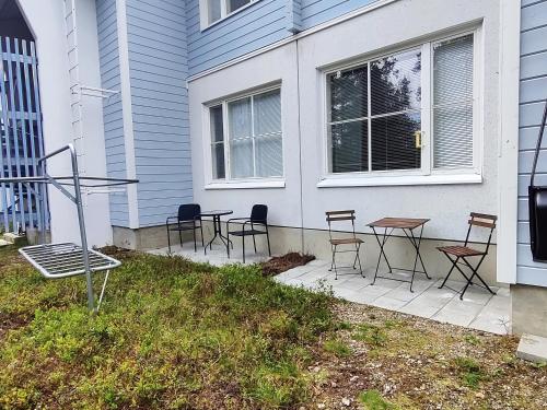 a patio with chairs and tables in front of a house at RöhköStar 109 in Äkäslompolo
