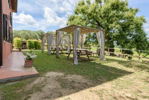 a picnic set up in the grass with a canopy at Villa Boscone by Mmega in Querce