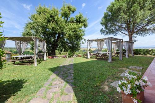 an outdoor wedding venue with tables and gazebos at Villa Boscone by Mmega in Querce