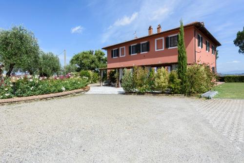 a large red house with a garden in front of it at Villa Boscone by Mmega in Querce