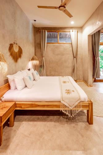 a bedroom with a large bed in a room at The Garten Living in Paje