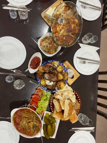 a black table with plates of food on it at Yeghevni Guest House in Odzun in Odzun