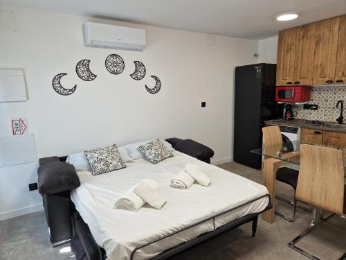 a bedroom with a bed with pillows on it at House totally refurbished in 2024, terrace in front of the sea, 1 min walk to the beach, aircon, wifi in Alicante