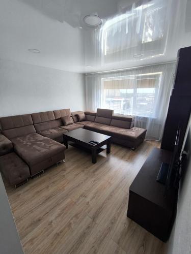 a living room with a couch and a coffee table at Sky View in Marijampolė