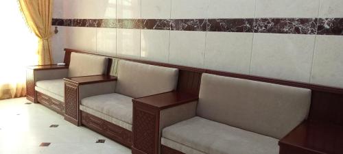a row of seats in a room with a wall at Dahlia Sohar Hotel Apartments in Sohar