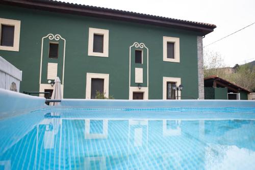 a house with a swimming pool in front of a building at Villa Palatina in Bolgues