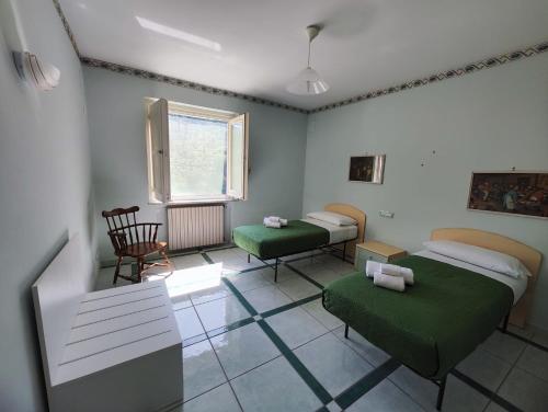 a hospital room with two beds and a window at gardeniapartment in Minori