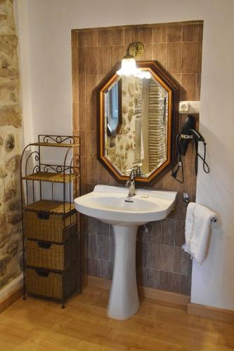 a bathroom with a sink and a mirror at Pensió Bellmirall in Girona