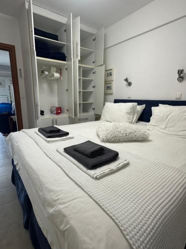 a white bed with two towels on top of it at Sunnyside Suite Afytos in Afitos