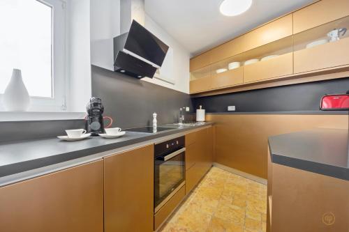 a kitchen with brown cabinets and a stove top oven at CASA MATTEO in Piran
