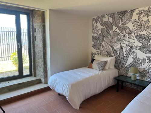 a bedroom with a bed and a window at Villa Elia in Seixas