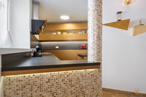 a kitchen with a counter and a brick wall at CASA MATTEO in Piran