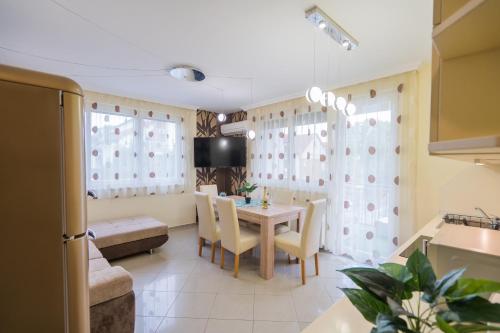a kitchen and dining room with a table and chairs at ★ BB Wellness Apartman ★ in Siófok