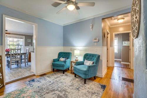 a living room with two chairs and a table at Walk to Mount Dora Historic District Cozy Home! in Mount Dora