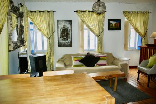 a living room with a couch and a table at The Corner House - Charming Rustic Home in the Heart of Monchique in Monchique