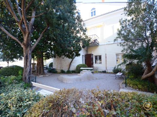 a park in front of a white building with trees at CASA MATTEO in Piran