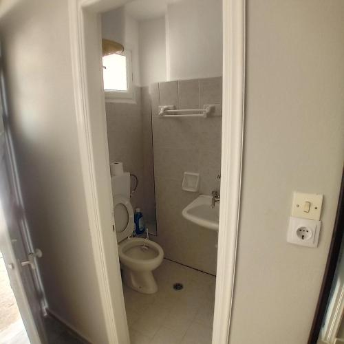 a bathroom with a toilet and a sink at Apartments in Amarynthos - Evoia in Amarynthos