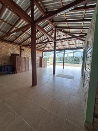 a large room with a brick wall and wooden ceiling at Pousada Dona Francisca in Florianópolis